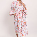Full-length view of Passionflower Kimono in cotton coral botanical print, perfect for summer lounging.