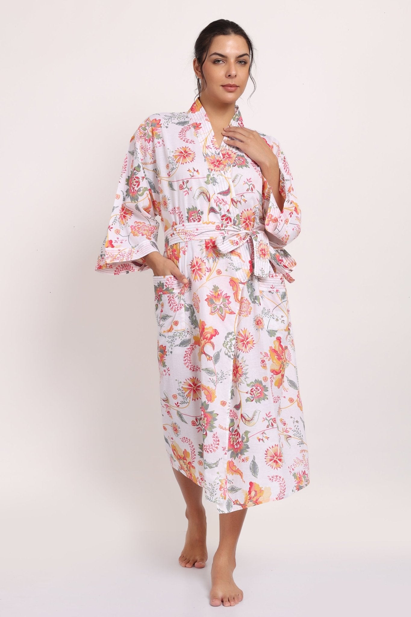 Full-length view of Passionflower Kimono in cotton coral botanical print, perfect for summer lounging.