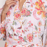 Side close-up of Passionflower Coral Kimono, showcasing stitching along the sleeve and kimono-style structure.