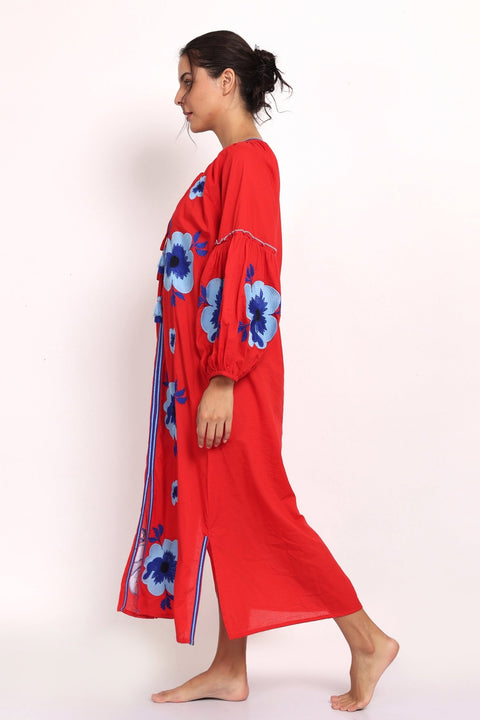 Side view of red cotton sundress showing sleeve details and embroidered floral pattern.