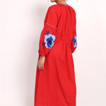 Back view of red and blue embroidered beach dress with relaxed fit and side pockets.