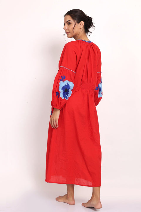Back view of red and blue embroidered beach dress with relaxed fit and side pockets.