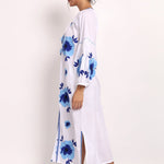 Side view of embroidered white cotton sundress showing flowy drape and hemline.