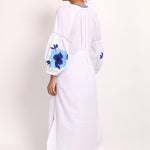 Back view of Romani sundress with floral detail and elasticized panel.
