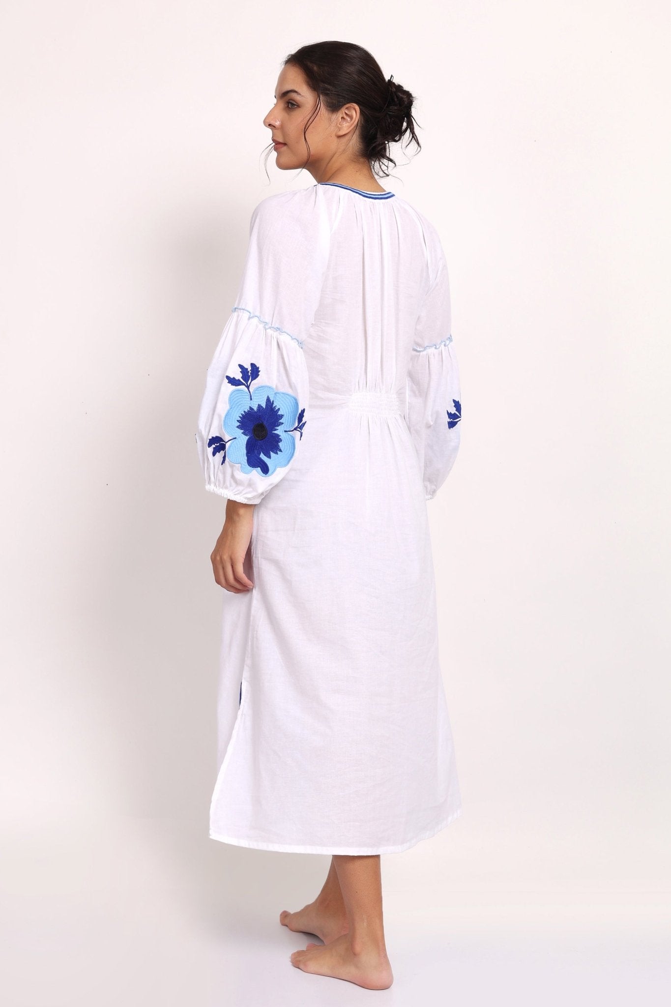 Back view of Romani sundress with floral detail and elasticized panel.