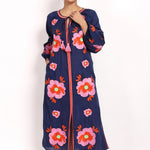 Full-length view of navy and pink embroidered sundress, sleeveless with v-neck.