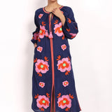 Full-length view of navy and pink embroidered sundress, sleeveless with v-neck.