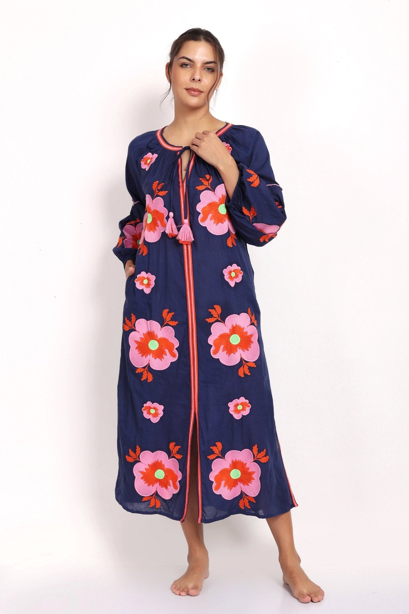 Full-length view of navy and pink embroidered sundress, sleeveless with v-neck.