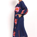 Side profile of cotton sundress with oversized pink floral details.