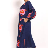 Side profile of cotton sundress with oversized pink floral details.