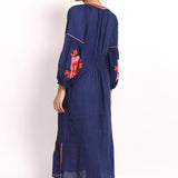 Back view of navy embroidered summer dress with elasticized panel.
