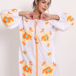 Model with arms raised in Romani sun dress, highlighting comfort and style.
