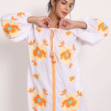 Model with arms raised in Romani sun dress, highlighting comfort and style.