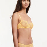 Side view of the Fleurs Demi Bra in Tender Yellow – transparent floral lace and soft uplift silhouette.