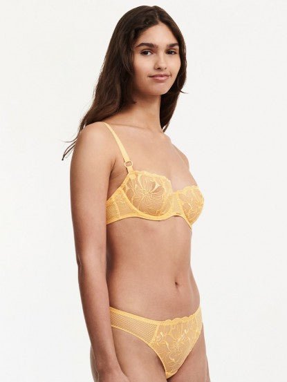 Side view of the Fleurs Demi Bra in Tender Yellow – transparent floral lace and soft uplift silhouette.