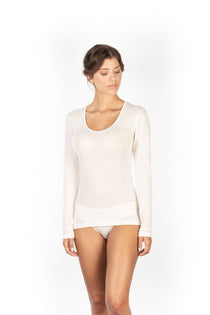 Woman wearing ivory wool and silk long sleeve top by EGI, with scoop neck and ribbed texture.