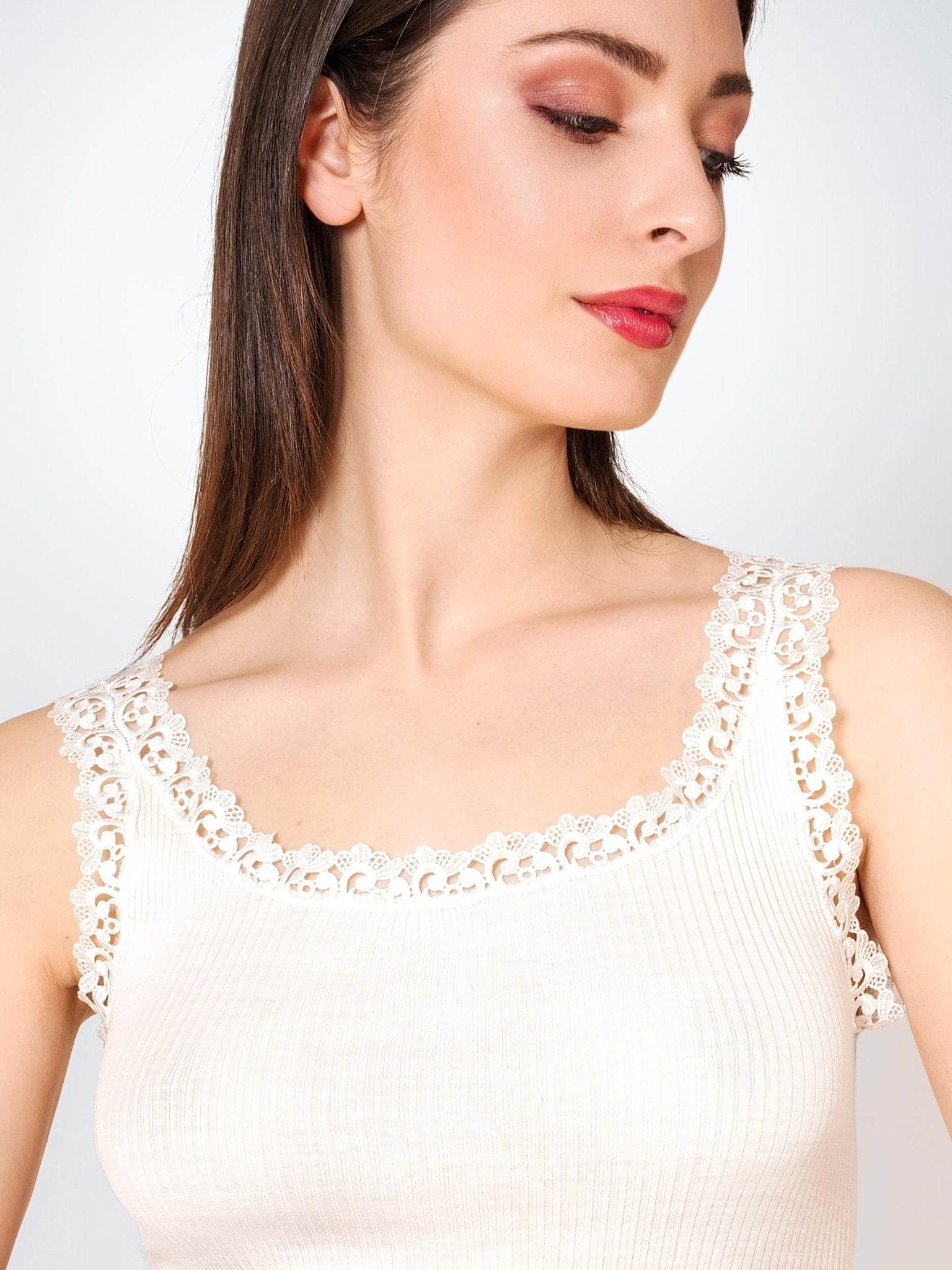 Close-up of Wool & Silk Lace Trimmed Camisole in ivory, showing delicate lace edging and ribbed knit texture.