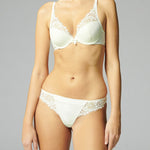Model wearing matching Simone Pérèle Wish bra and tanga in Natural, showcasing a coordinated lingerie set.