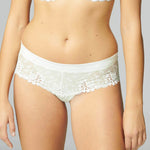Close up of Simone Perele Wish Shorty Brief Natural on model featuring Guipure embroidery and satin Jacquard waistband.