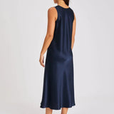 Back view of Model walking in navy long silk chemise showcasing bias-cut drape and elegant movement.