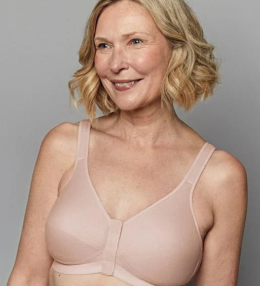 Smiling model wearing Royce Comfi Cotton Wirefree Press Stud Front Open Bra Blush, showing soft blush cotton and gentle bust shaping, from The Foundation.
