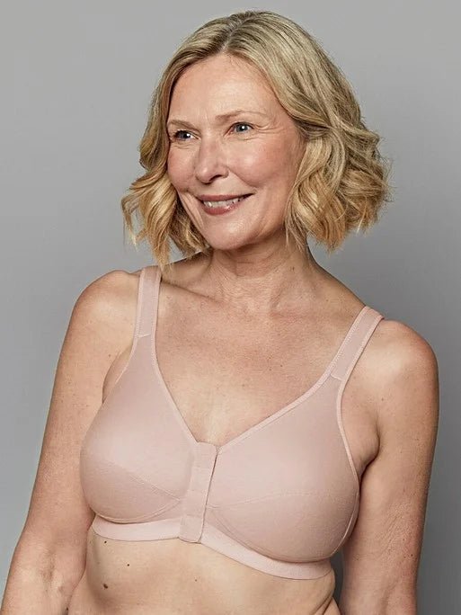 Smiling model wearing Royce Comfi Cotton Wirefree Press Stud Front Open Bra Blush, showing soft blush cotton and gentle bust shaping, from The Foundation.