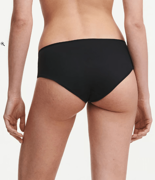 Back view of Chantelle Norah Chic Covering Shorty Brief Black on model highlighting seamless design and soft, eco-friendly fabric.