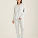 Model wearing Papinelle Feather Soft V-Neck LS Top and Jogger Set in Crystal Blue/Cream with a relaxed winter-ready fit.