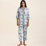 Front view of Papinelle Toile De Jouy Crop PJ Set in cotton print, featuring button-up shirt and cropped pants with drawstring waist.