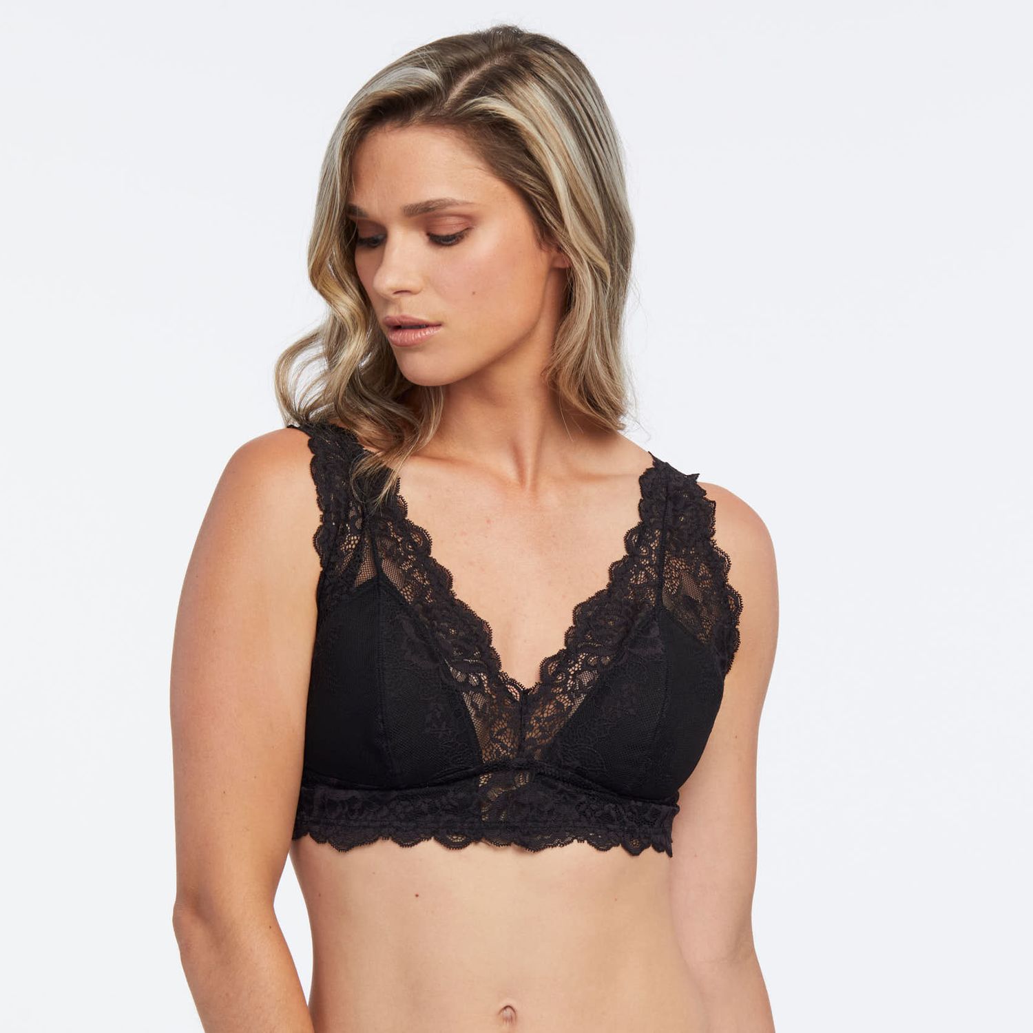 Model wearing Janira Greta Bralette in Black, featuring scalloped lace neckline and wireless support.