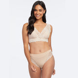 Woman modelling Janira Greta Lace Bralette in Dune, paired with matching lace briefs.