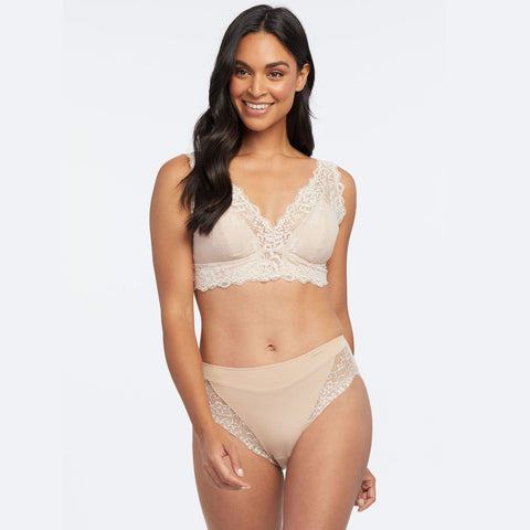 Woman modelling Janira Greta Lace Bralette in Dune, paired with matching lace briefs.