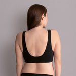 Back view of Anita Seamless Maternity Sleep Bra Weiss Black on model, displaying broad straps and smoothing finish, available at The Foundation.