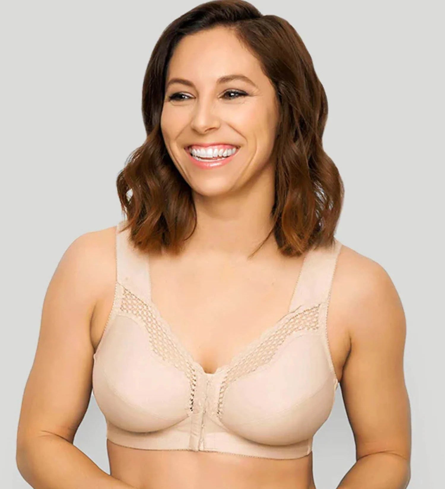 Woman wearing a beige bra against a plain background