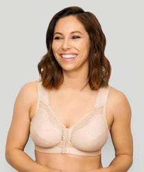 Woman wearing a beige bra against a plain background