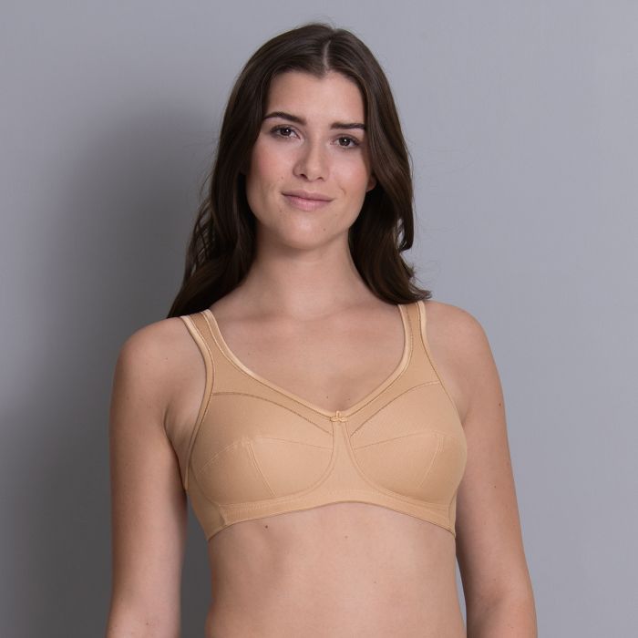 Model in Anita Jana Support Bra Deep Sand, front view showing soft cotton piqué, natural beige tone, and supportive coverage, available at The Foundation.