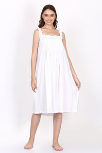 Model in white strappy cotton nightie with pintuck detail and broderie lace neckline, front view.