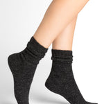 Model wearing Bleuforet Alpaca Wool Socks in Anthracite, mid-length women’s socks with gentle ribbing and reinforced heels and toes, available at The Foundation.
