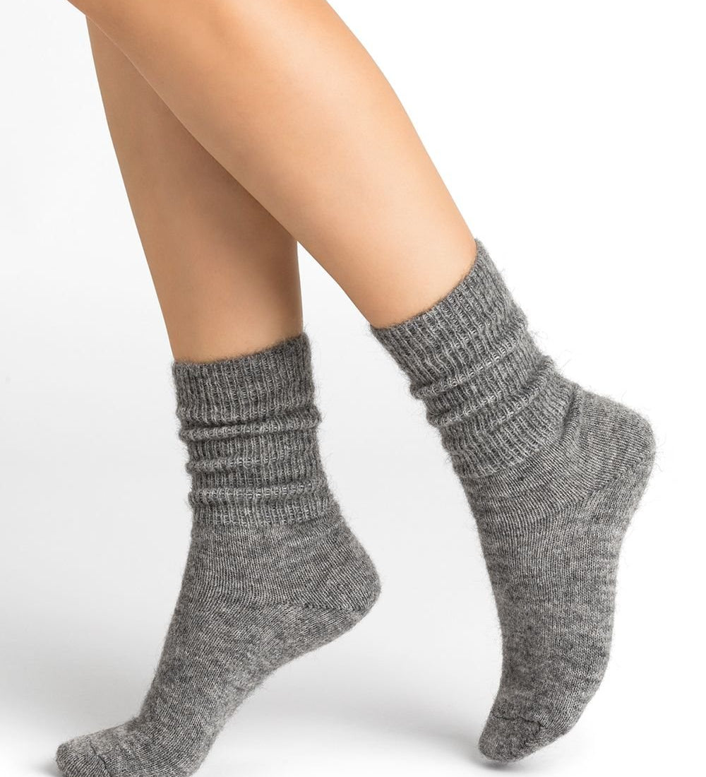 Bleuforêt Alpaca Wool Socks in Gris Moyen grey worn mid-calf with ribbed knit and reinforced heel, available at The Foundation.