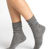 Bleuforêt Alpaca Wool Socks in Gris Moyen grey worn mid-calf with ribbed knit and reinforced heel, available at The Foundation.