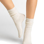 Model wearing Bleuforet Alpaca Wool Socks in Ecru, mid-length women’s socks with gentle ribbing, reinforced heels and toes, available at The Foundation.