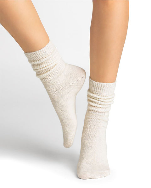Model wearing Bleuforet Alpaca Wool Socks in Ecru, mid-length women’s socks with gentle ribbing, reinforced heels and toes, available at The Foundation.