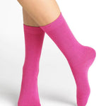 Bleuforêt Wool Cashmere Socks in vibrant Rosa pink worn mid-calf, showcasing soft cosy knit and French-made luxury, available at The Foundation.