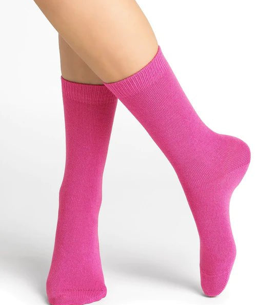 Bleuforêt Wool Cashmere Socks in vibrant Rosa pink worn mid-calf, showcasing soft cosy knit and French-made luxury, available at The Foundation.