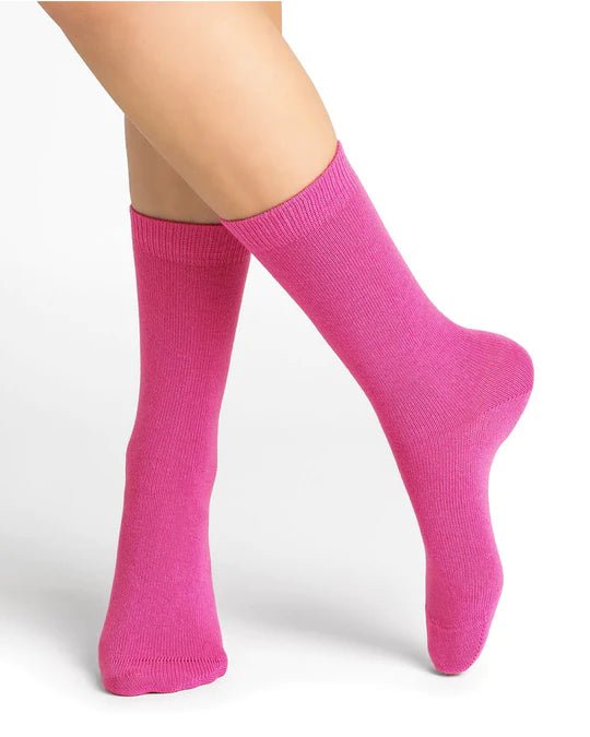 Bleuforêt Wool Cashmere Socks in vibrant Rosa pink worn mid-calf, showcasing soft cosy knit and French-made luxury, available at The Foundation.