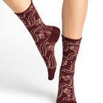 Model wearing Bleuforet Velvet Cotton Wild Flowers Mid Socks in Chianti, featuring a wild flower print and glittery threads, available at The Foundation.