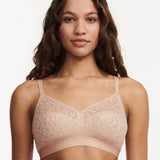 Model wearing the Norah Wirefree Bra in Golden Beige by The Foundation—wire-free comfort with floral stretch lace.