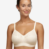Model wearing Chantelle Norah Wirefree Support Bra Pearl, front view highlighting floral lace and seamless fit, available at The Foundation.