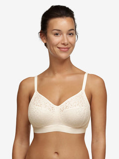 Model wearing Chantelle Norah Wirefree Support Bra Pearl, front view highlighting floral lace and seamless fit, available at The Foundation.