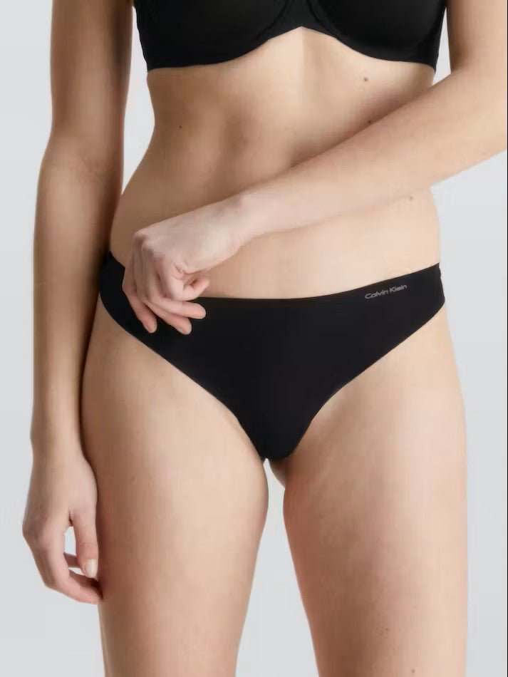 Front view of Calvin Klein Invisibles Thong Black, a seamless microfibre thong with a smooth, invisible fit.